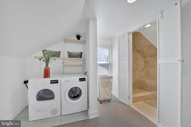 clothes washing area with baseboards and separate washer and dryer