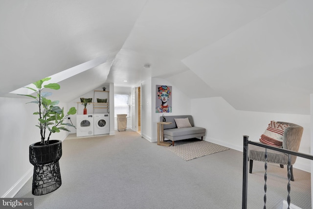 living area featuring lofted ceiling, carpet floors, separate washer and dryer, and baseboards