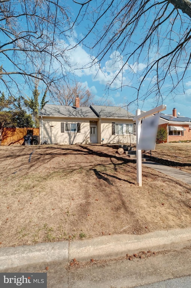 single story home featuring a chimney