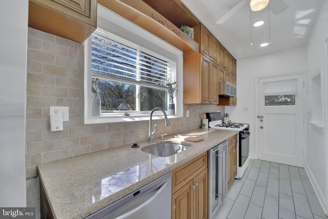 kitchen featuring white appliances, beverage cooler, light stone counters, a sink, and backsplash