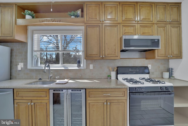 kitchen with stainless steel microwave, gas stove, a sink, beverage cooler, and dishwasher