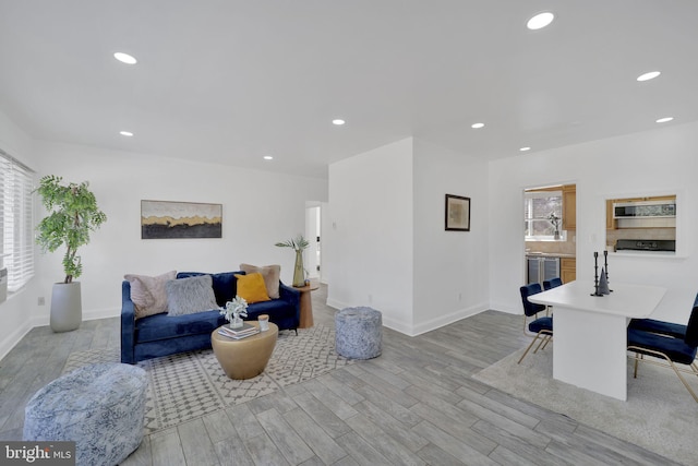 living area with plenty of natural light, wood finished floors, and recessed lighting