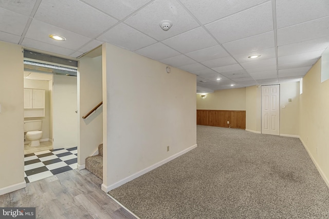 finished below grade area with recessed lighting, stairs, and a drop ceiling