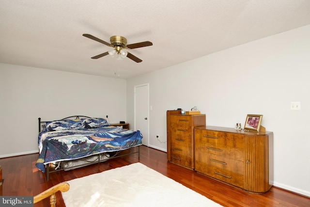 bedroom with ceiling fan and dark hardwood / wood-style flooring