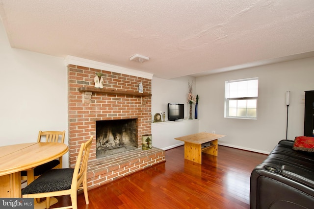 living room with a fireplace, dark hardwood / wood-style flooring, and a textured ceiling