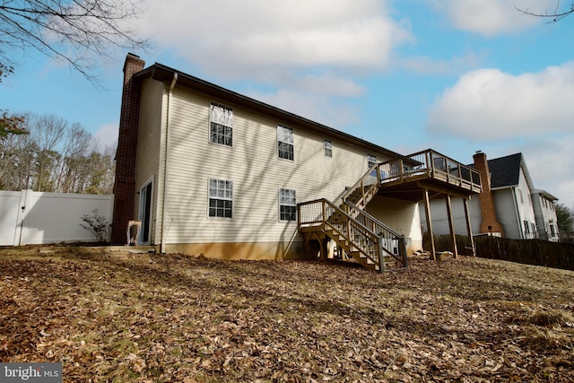 back of house with a wooden deck