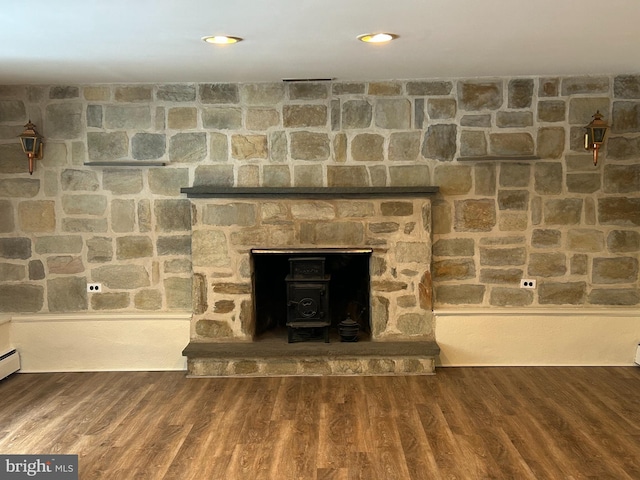 details with hardwood / wood-style flooring and a wood stove