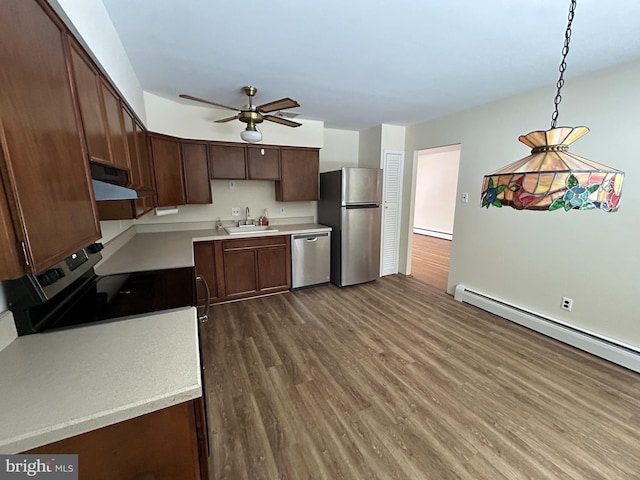 kitchen featuring pendant lighting, sink, ceiling fan, stainless steel appliances, and dark hardwood / wood-style flooring