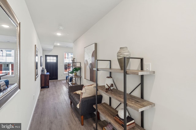 corridor with recessed lighting, wood finished floors, and baseboards