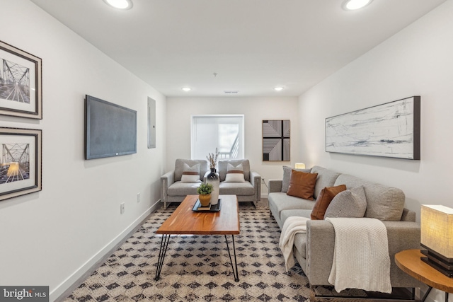 living room with electric panel, recessed lighting, visible vents, and baseboards