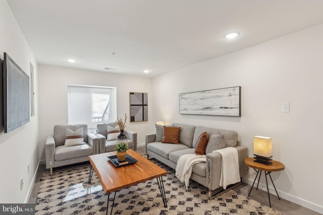 living area featuring recessed lighting, baseboards, and wood finished floors