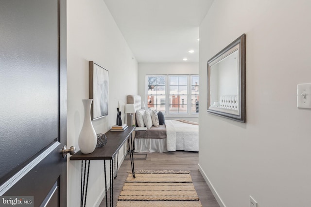 bedroom featuring recessed lighting, wood finished floors, and baseboards