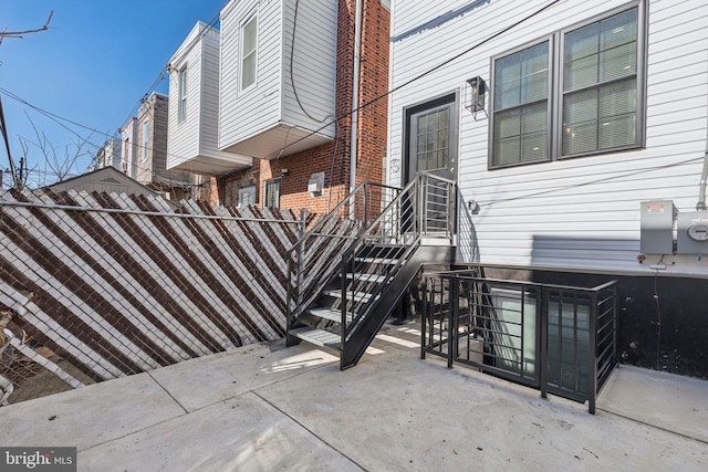 doorway to property featuring a patio area and fence