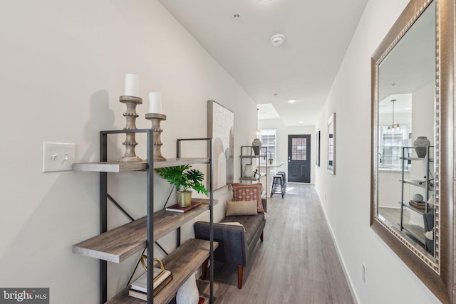 hallway with baseboards and wood finished floors