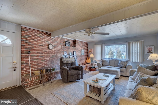 living room featuring visible vents, beamed ceiling, brick wall, and a ceiling fan