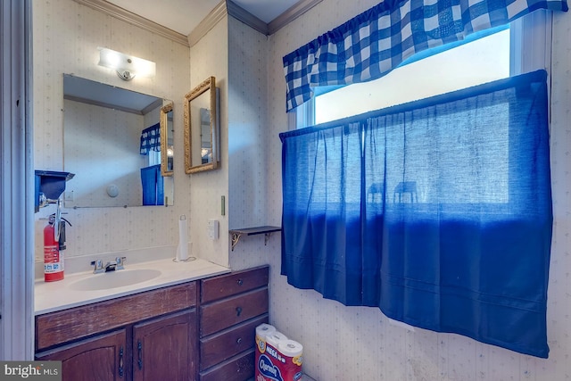 bathroom featuring vanity, wallpapered walls, and crown molding