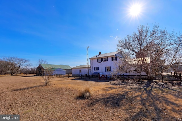 view of yard featuring an outbuilding and fence