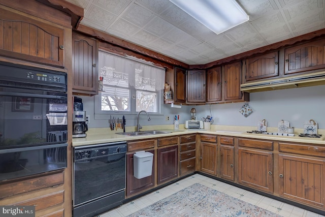 kitchen featuring an ornate ceiling, a sink, light countertops, dishwasher, and white stovetop