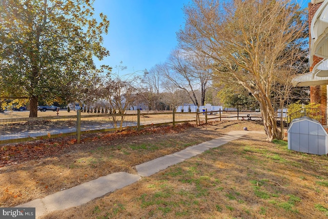 view of yard with a rural view and fence