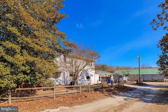 exterior space featuring driveway and a fenced front yard