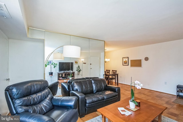 living area featuring a chandelier and baseboards