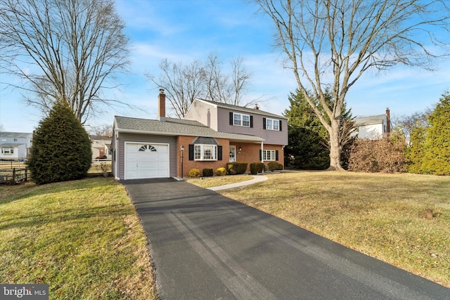 view of front of home with a garage and a front yard