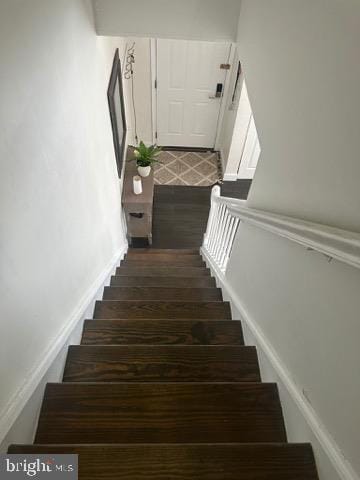 stairs featuring hardwood / wood-style flooring