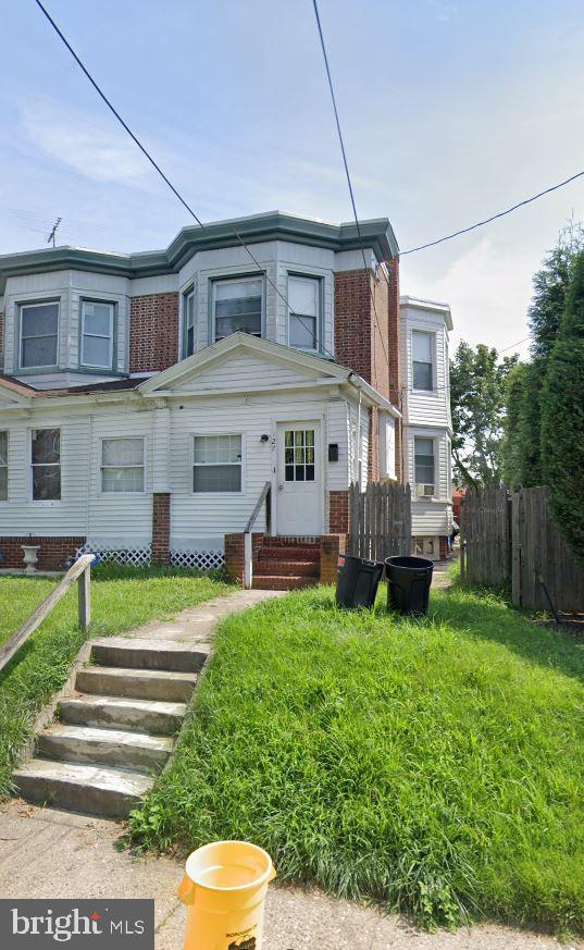 townhome / multi-family property featuring entry steps and fence