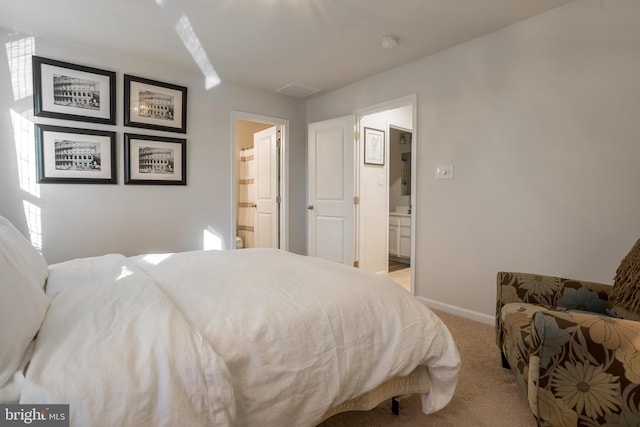 bedroom with light carpet, connected bathroom, and baseboards