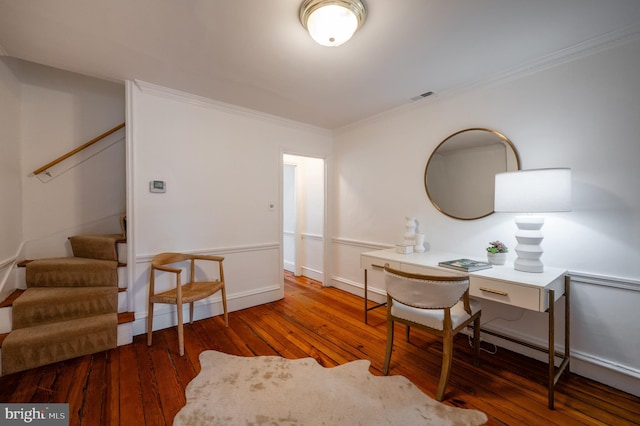 home office featuring crown molding, visible vents, baseboards, and hardwood / wood-style floors