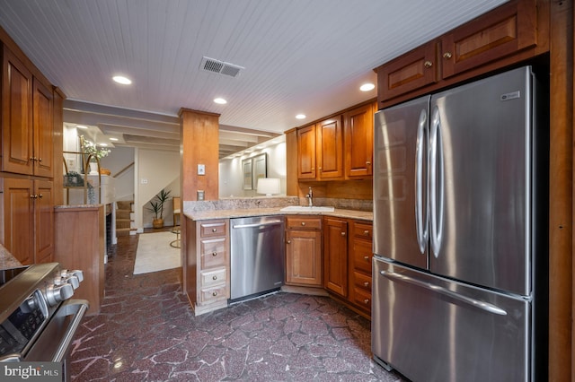 kitchen featuring brown cabinetry, visible vents, recessed lighting, appliances with stainless steel finishes, and a sink
