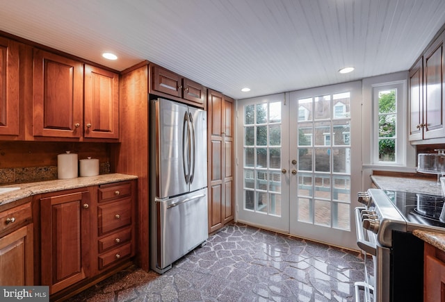 kitchen with brown cabinetry, french doors, recessed lighting, and stainless steel appliances