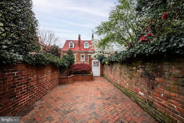 view of patio with fence and a gate