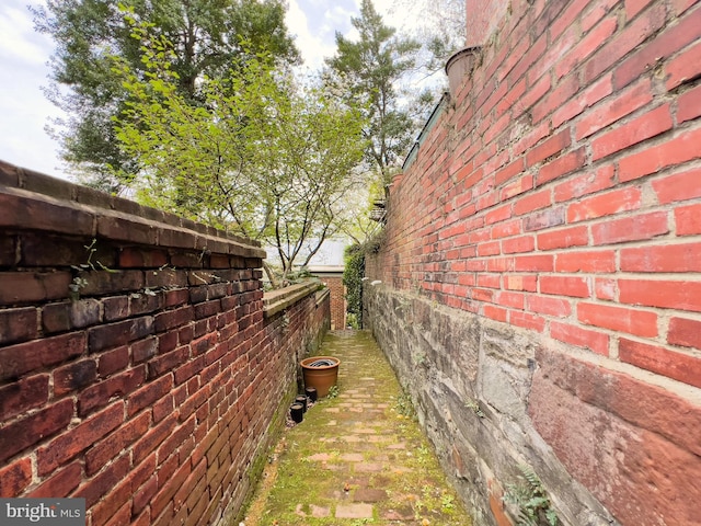 view of side of home featuring fence