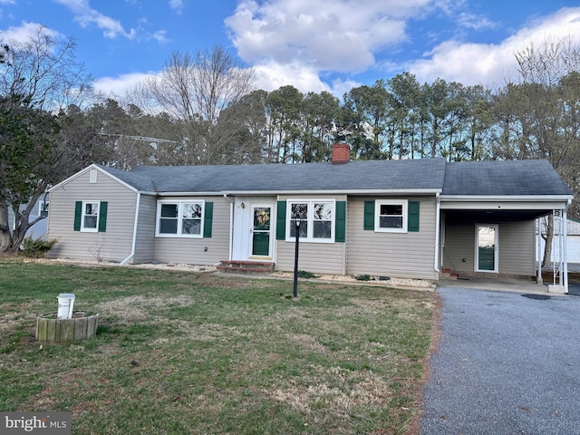 single story home with a chimney, a front lawn, entry steps, and a carport