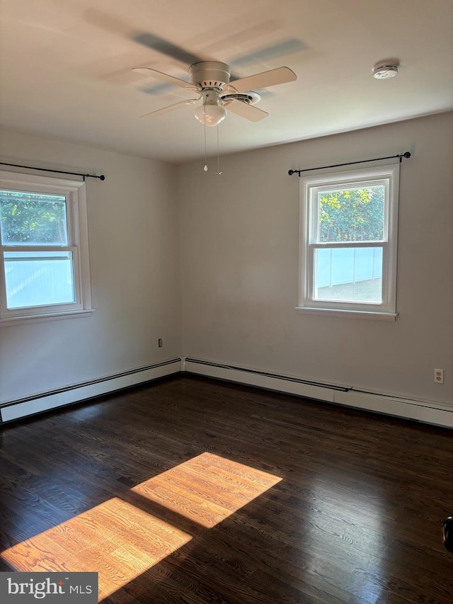 spare room with a baseboard radiator, ceiling fan, and wood finished floors