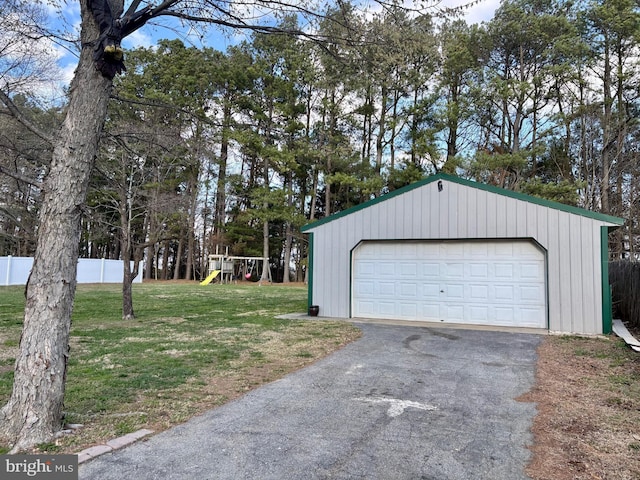detached garage featuring fence