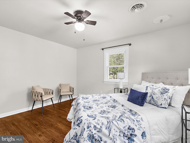 bedroom with wood finished floors, baseboards, ceiling fan, and visible vents