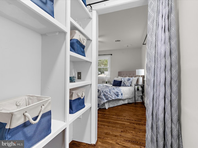 bedroom with visible vents and wood finished floors