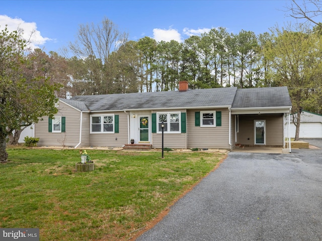 ranch-style home with aphalt driveway, entry steps, a chimney, a front yard, and a carport