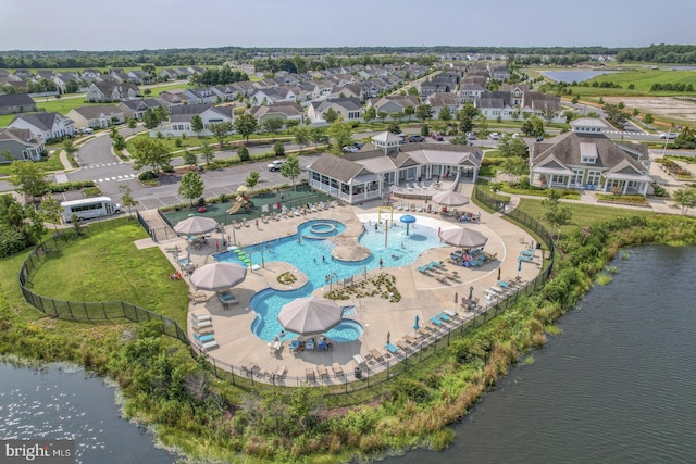 drone / aerial view featuring a water view and a residential view