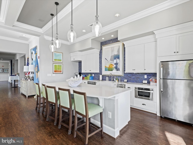 kitchen featuring light countertops, appliances with stainless steel finishes, white cabinets, and a center island