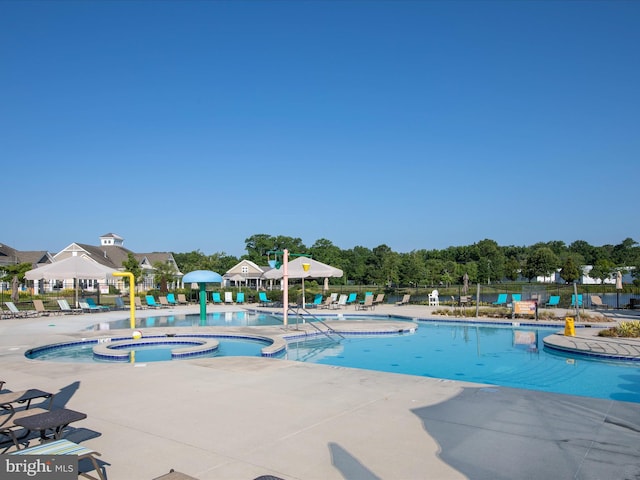 view of swimming pool with a pool with connected hot tub, a gazebo, fence, and a patio