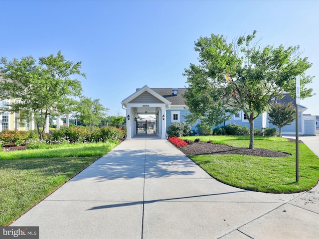 view of front of property with concrete driveway and a front yard