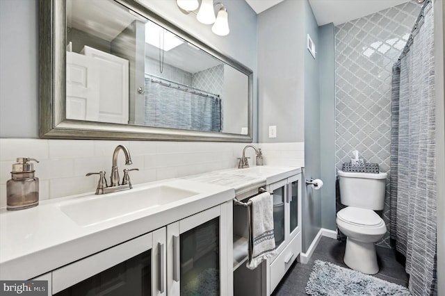 bathroom with vanity, backsplash, tile patterned floors, and toilet