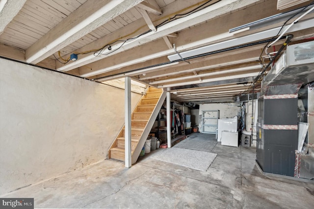 basement featuring fridge and heating unit