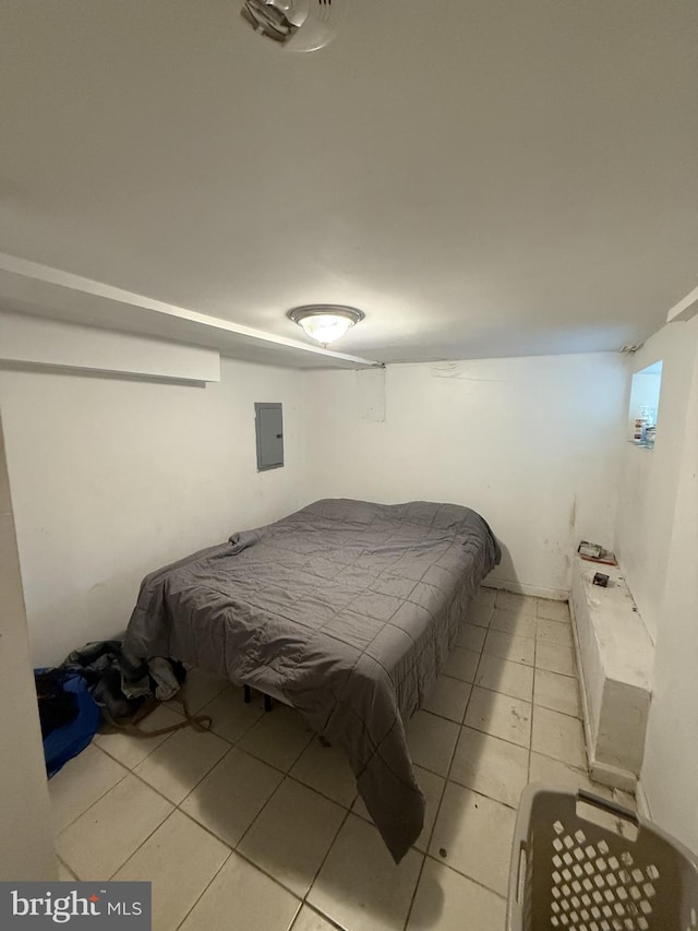 bedroom with light tile patterned floors and electric panel