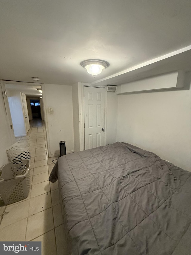 bedroom featuring light tile patterned flooring and a closet