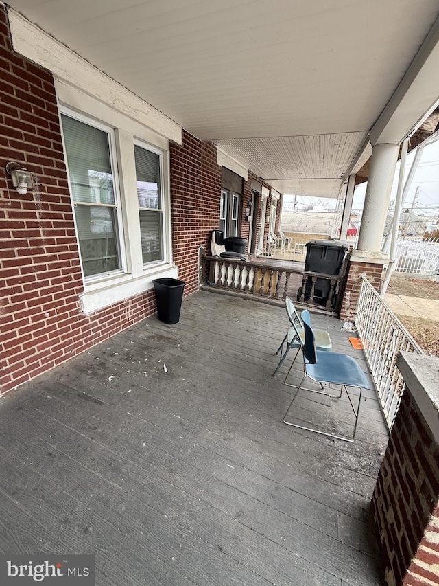 wooden terrace featuring a porch