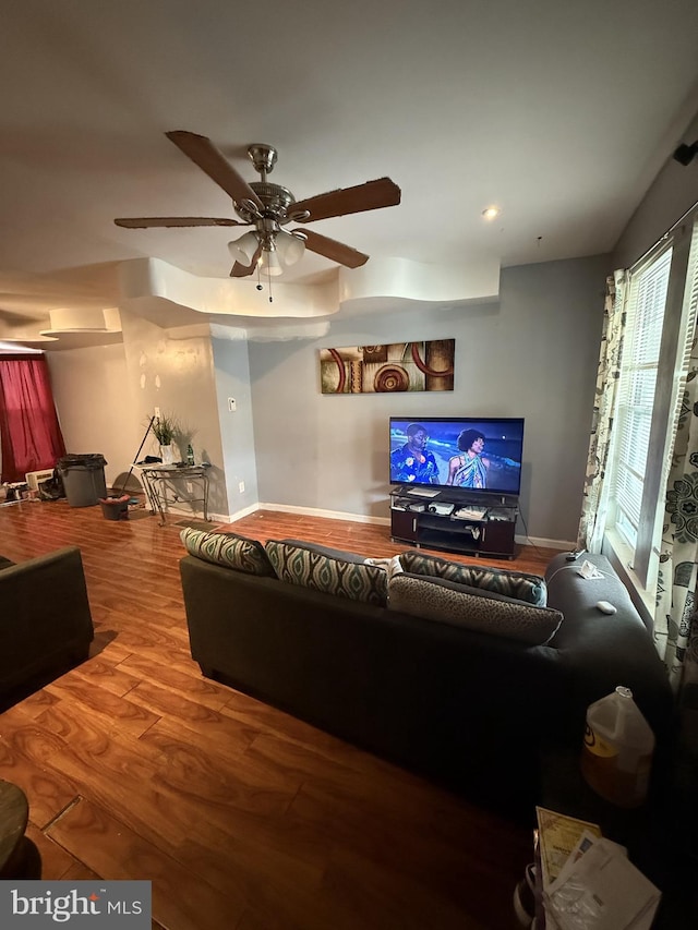 living room with hardwood / wood-style floors and ceiling fan